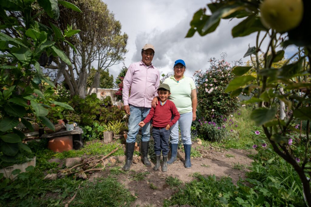 Image of a Latino family of three in a rural setting